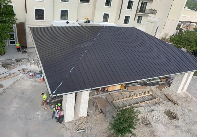 Metal roofing installation team working on a commercial building in Durant