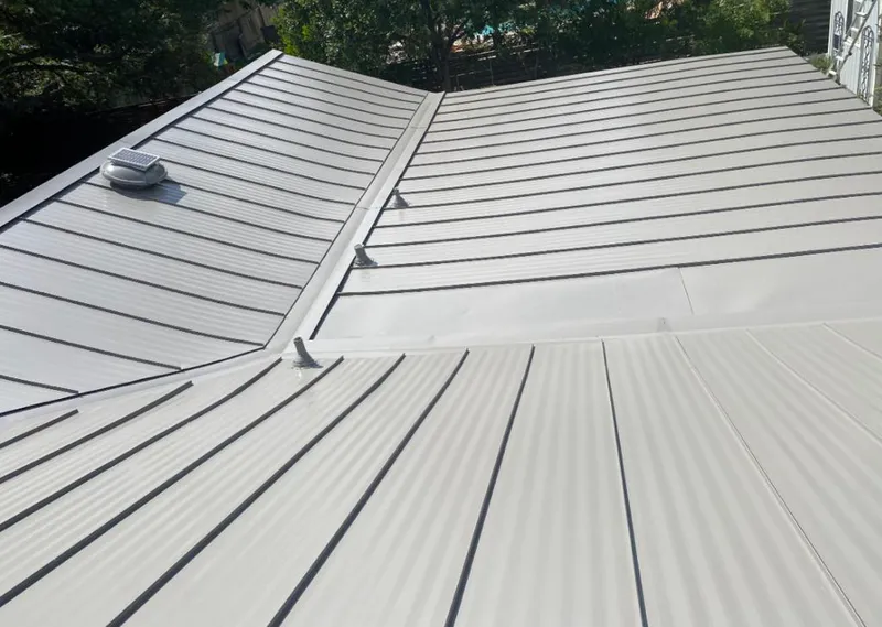 Solar attic fan installed on a metal roof for Roof Ventilation in Durant